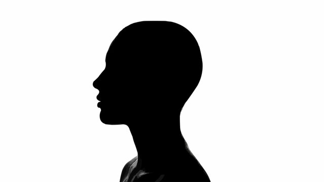 Silhouette of a bald womans head in profile.