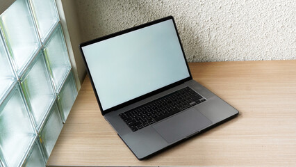 Modern Space Gray MacBook Pro Mockup on Minimalist Wooden Desk with Blank Screen