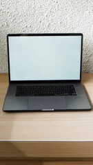 Modern Space Gray MacBook Pro Mockup on Minimalist Wooden Desk with Blank Screen