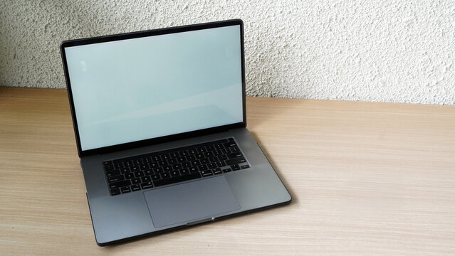 Modern Space Gray MacBook Pro Mockup on Minimalist Wooden Desk with Blank Screen