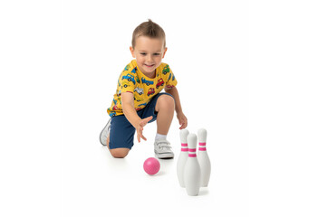 Childhood play and physical activity through a bowling game helps a child develop motor skills and coordination during an indoor hobby session focused on early development and active recreation goal