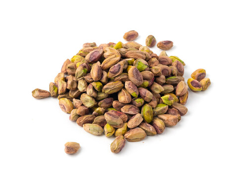 Fried salt pistachio nuts isolated. Baked pistachios pile, roasted green pistache fruits on white