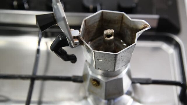 Making coffee with Moka pot. Italian espresso coffee in moka close-up.