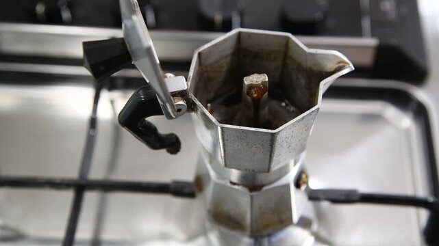 Making coffee with Moka pot. Italian espresso coffee in moka close-up.