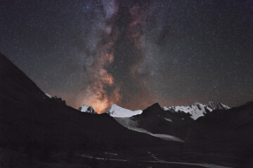 The Milky Way against the backdrop of the snow-capped ridges of the Altai Mountains. This photo was taken by combining and averaging 30 original frames for noise. Each frame was shot at ISO 10000