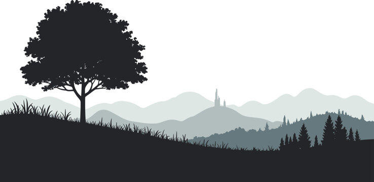 Silhouette of a lone tree on a hill with distant mountains