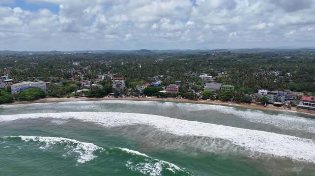 Galle, Sri Lanka, November 3, 2025: Devata Beach in the galle city and surfers riding in the waves