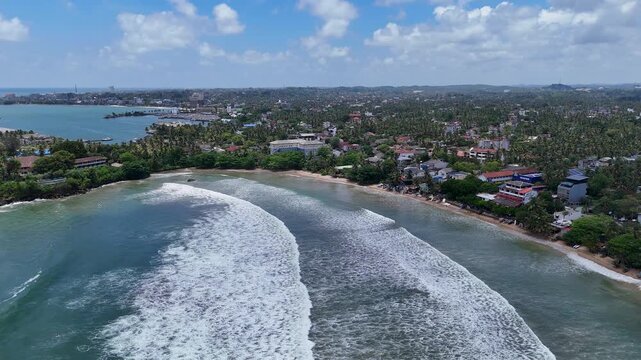 Galle, Sri Lanka, November 3, 2025: Devata Beach in the galle city and surfers riding in the waves