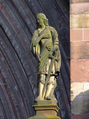 Obraz premium Telephoto close-ups of sculptural details of Freiburger Münster cathedral, including Gothic saints, prophets, gargoyles, ornamental figures and waterspouts carved in red , DE, Mart 2011
