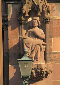 Telephoto close-ups of sculptural details of Freiburger M&uuml;nster cathedral, including Gothic saints, prophets, gargoyles, ornamental figures and waterspouts carved in red , DE, Mart 2011
