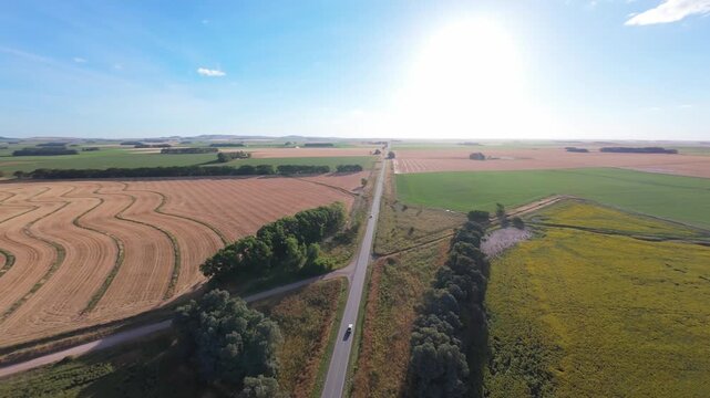 Aerial 180-degree panorama rotating right over agricultural fields and hills, Tandil landscape, 4K 