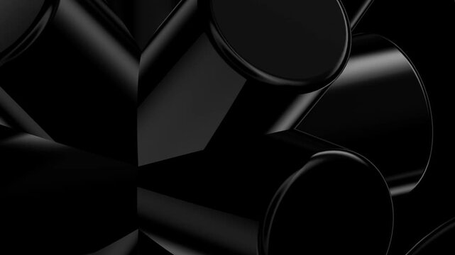 Extreme close-up of high-gloss black 3D cylinders showing intricate surface reflections and dark depth in a studio setting.