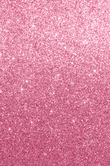 Pink glitter sparkle background with shimmering texture and star highlights for design