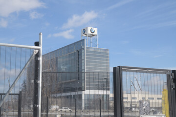 Fototapeta premium through fence view of BMW Toronto, a dealer, located at 1 Sunlight Park Rd, seen from Bayview Path