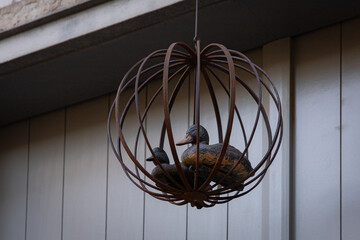 Figurki dwóch kaczek w ażurowej, metalowej kuli © Magdalena