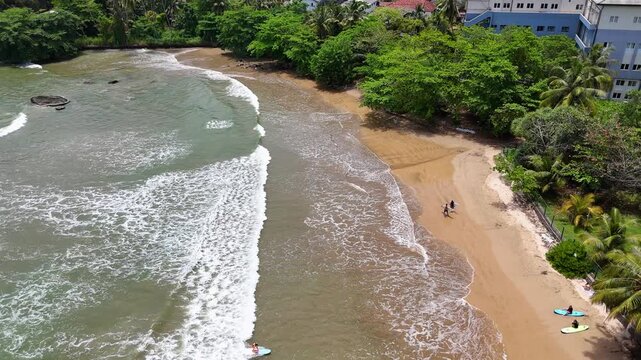 Galle, Sri Lanka, November 3, 2025: Devata Beach in the galle city and surfers riding in the waves