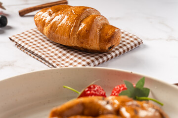 Croissant pastry on a napkin. Delicious pastries for breakfast. Flat lay concept.