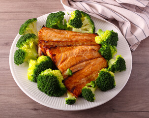 Spicy salmon fillet with broccoli on plate