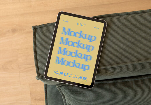 Real photo of Tablet Placed on Couch. PSD mockup ready for your design.