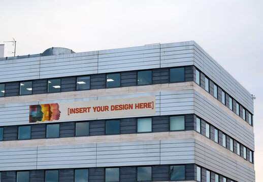 Real photo of Building With Blank Sign in Urban Area. PSD mockup for your logo design.