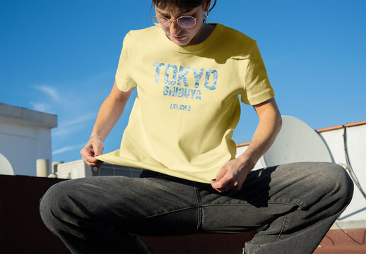 Real photo of short-sleeved T-Shirt Model in Bright Sun. PSD template mockup.