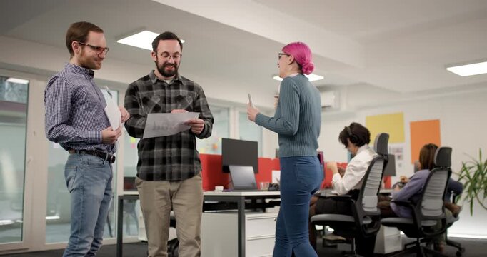 Discussion among team members in an office about project details with different views of participants and their activities