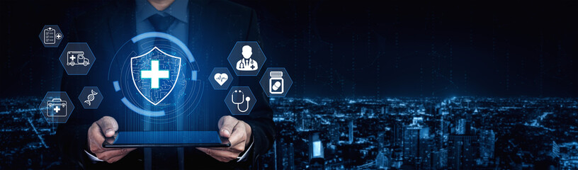 Businessman in suit holding tablet with digital health icons representing modern healthcare...
