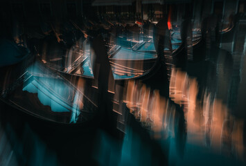 abstract view of gondolas moving on the water with intentional camera movement in Venice Italy