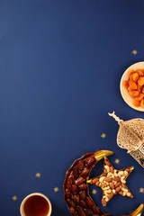 Fotobehang Natuur Park Ramadan Iftar flat lay with dates, nuts, apricots and lantern on dark blue background.  © photoguns