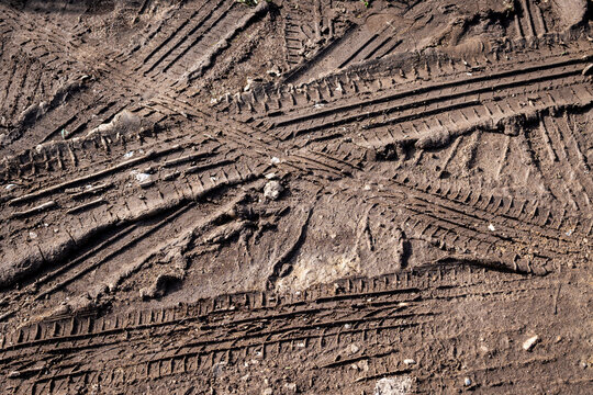 Marks of car tires in the fresh mud. Top view photo.