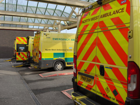 NHS North West Ambulance Service ambulances queued   up outside Bolton Royal Hospital accident and emergency department. 