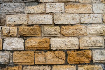 Old masonry wall made of regular stones.