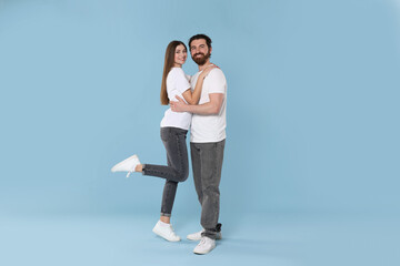 Obraz premium Romantic date. Portrait of lovely couple on light blue background