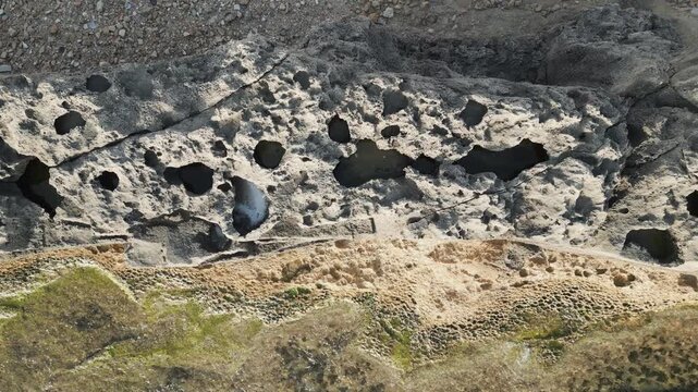 Top view of ancient Phoenician wall located on the Mediterranean shore in Batroun, Lebanon. Drone video.