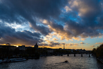 Fototapeta premium City views of Paris, streets, roands, buildings, Seine river on autumn evening tweenlight