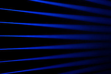 Wide blue beams on black. Laser beams. © puhimec