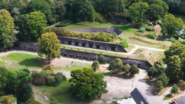 brick barracks embedded grassy embankments stepped earthworks tree lined paths open courtyards layered historic fortifications wooded landscape roman fort long castellum fectio utrecht 