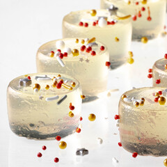 A close up of Champagne jelly shooters with sprinkles for Lunar New Year.