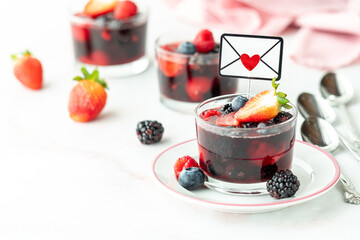 Mixed berry jelly cups for Valentine's Day with copy space in bottom left corner