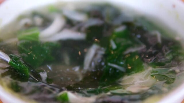 Making miso soup with fried tofu and wakame seaweed