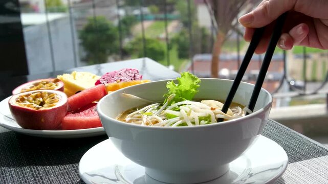 Vietnamese pho soup vermicelli soup on the street small eatery cooking fa soup in Vietnam street food dirt delicious travel tourists local population.