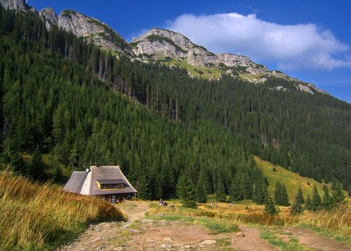 Mountain shelter in the Tatra Mountains. Rocky peaks and green slopes create a majestic backdrop for the traditional architecture.