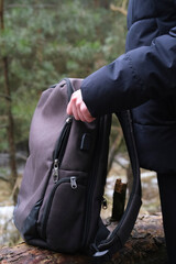Obraz premium Male hands unfastening the zipper on a backpack. Touristic bag