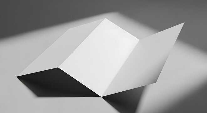 White folded brochure or leaflet with multiple panels open, casting shadows on a grey background.