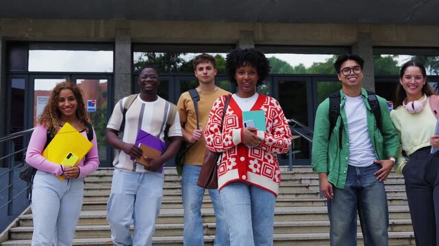 Cheerful group of young multiracial student looking at camera having fun outside at university campus. Diverse happy friend hugging posing smiling together outdoor. Community and friendship