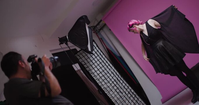 Model showcases fashion in studio photoshoot with vibrant pink backdrop and dynamic poses for creative expression