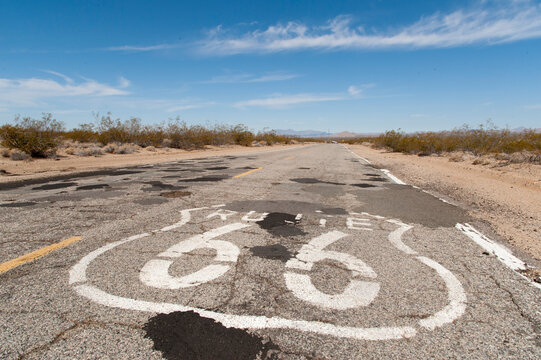 USA, California, Goffs.  Route 66 sign painted on a disused portion of the famous highway.