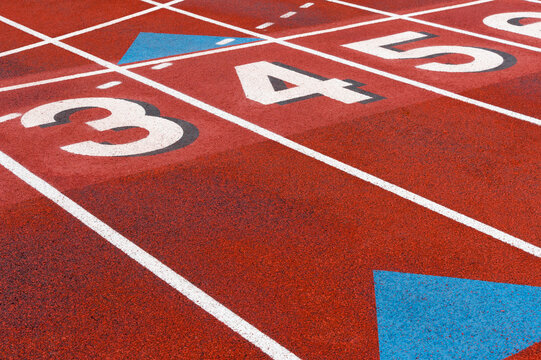 USA, WA, Seattle.  Lane numbers on high school sports field.