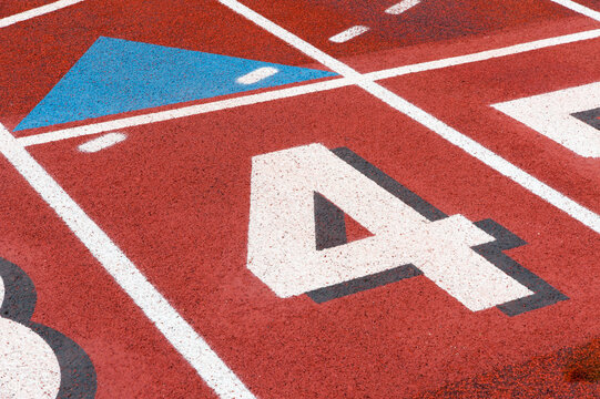 USA, WA, Seattle.  Lane numbers on high school sports field.