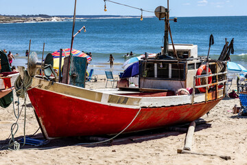 Artisanal fishing boat resting on the beach in Punta del Diablo, Uruguay.